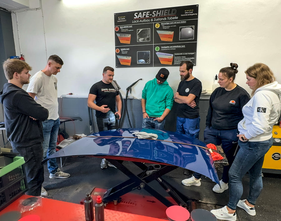 Tim Kohl explaining work on a bonnet to a group during a polishing workshop
