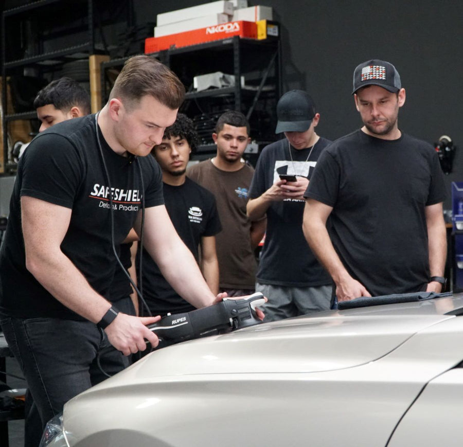 Tim Kohl polishing a vehicle during hands-on training in Orlando with other participants